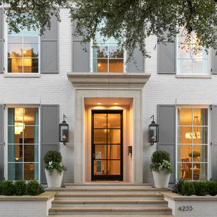 Inspiration for a transitional entryway remodel in Dallas with white walls and a glass front door