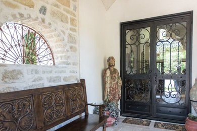 Mediterranean entrance in Houston with brick flooring and a double front door.