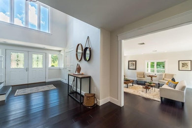 Example of a large transitional bamboo floor and brown floor double front door design in Boston with gray walls and a white front door