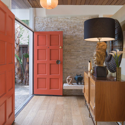 Inspiration for a mid-sized transitional ceramic tile and brown floor entryway remodel in Los Angeles with a red front door and beige walls