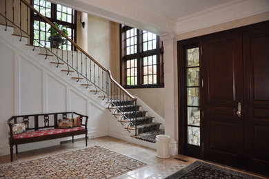 Mid-sized transitional ceramic tile entryway photo in New York with beige walls and a dark wood front door