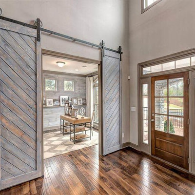 Entryway - large country dark wood floor entryway idea in Atlanta with beige walls and a medium wood front door