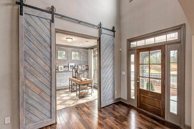 Entryway - large country dark wood floor entryway idea in Atlanta with beige walls and a medium wood front door