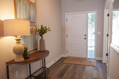 Inspiration for a medium sized traditional front door in Minneapolis with a single front door, grey walls, vinyl flooring, a white front door and brown floors.