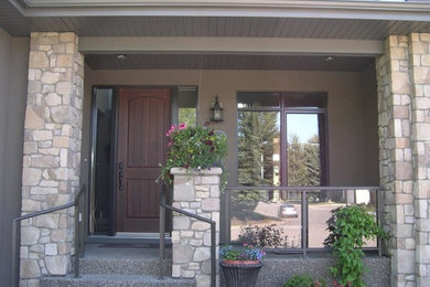 Example of a mid-sized classic entryway design in Calgary with brown walls and a dark wood front door