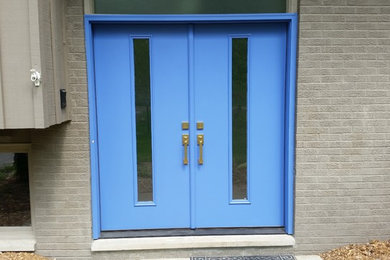 Minimalist entryway photo in Detroit with a blue front door