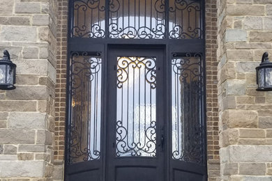 Inspiration for a mediterranean entryway remodel in Omaha with a metal front door