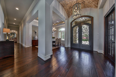 Medium sized traditional foyer in Houston with grey walls, dark hardwood flooring, a double front door, a grey front door and feature lighting.