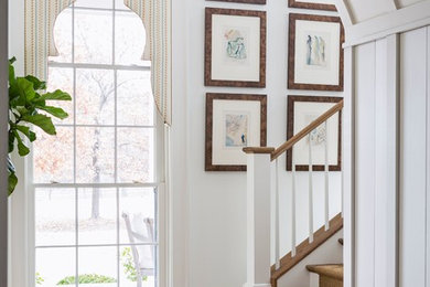 Inspiration for a large timeless dark wood floor and brown floor foyer remodel in Little Rock with white walls