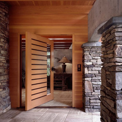Pivot front door - contemporary pivot front door idea in Seattle with a medium wood front door