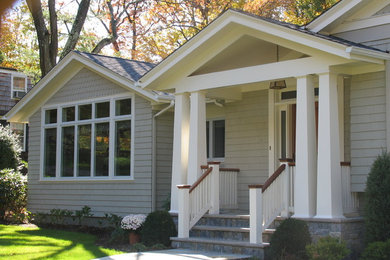 This is an example of a small classic front door in New York with grey walls, a single front door and a medium wood front door.