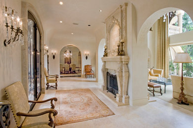This is an example of an expansive traditional foyer in Houston with beige walls, travertine flooring, a double front door and a black front door.