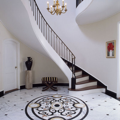 Huge elegant marble floor foyer photo in Santa Barbara with beige walls