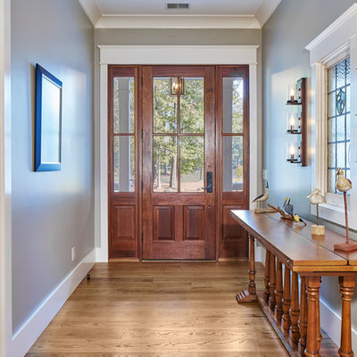 Inspiration for a mid-sized transitional medium tone wood floor and brown floor entryway remodel in Charleston with gray walls and a medium wood front door