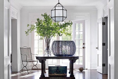 Photo of a large classic foyer in Other with white walls, dark hardwood flooring, a double front door and a glass front door.