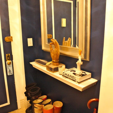 Entry way - navy blue hi gloss walls and the family's collection of wellies for