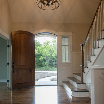 Entry with 8-ft arched walnut door