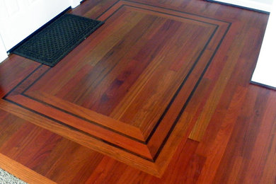 Example of a classic medium tone wood floor and brown floor single front door design in Seattle with white walls and a white front door