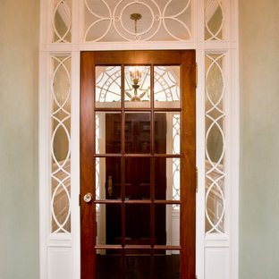 Example of a small classic dark wood floor entryway design in Boston with white walls and a dark wood front door