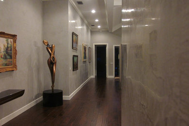 Large minimalist dark wood floor entryway photo in New York with gray walls and a dark wood front door