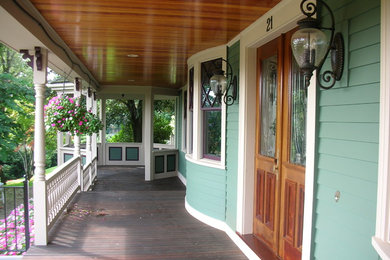 Inspiration for a medium tone wood floor double front door remodel in Boston with green walls and a medium wood front door