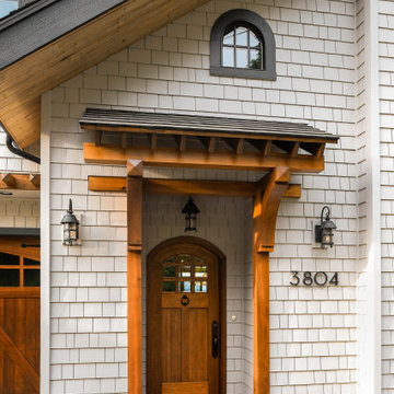 Exterior makeover with stained cedar shake siding and wood accents