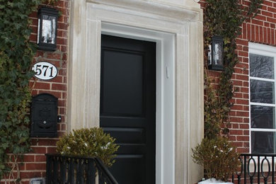 Example of a large single front door design in Toronto with a black front door
