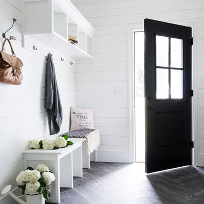 Entryway - small cottage porcelain tile and gray floor entryway idea in New York with white walls and a black front door