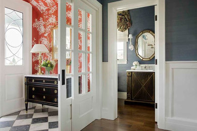 Example of a huge classic marble floor entryway design in Los Angeles with blue walls and a white front door