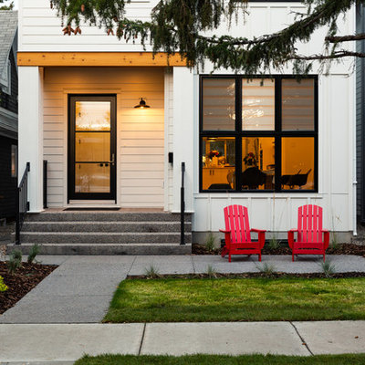 Example of a cottage entryway design in Calgary with a glass front door