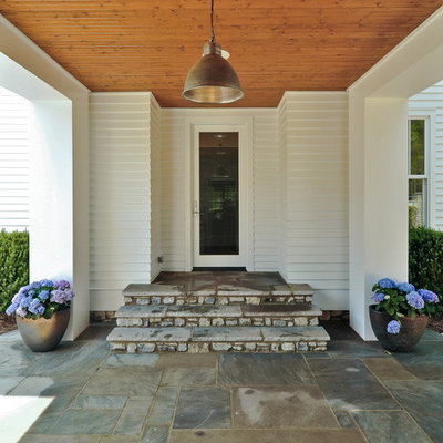 Example of a cottage entryway design in Nashville with a glass front door