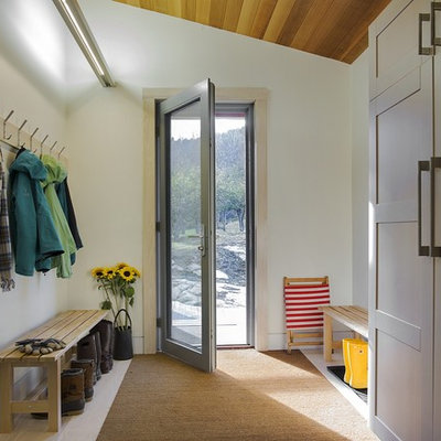 Country light wood floor entryway photo in Boston with white walls and a glass front door
