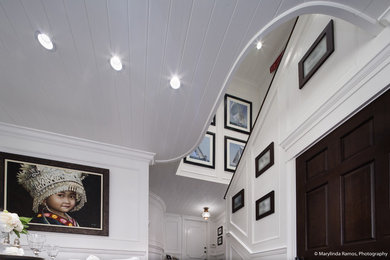 Photo of a nautical foyer in Boston with white walls, dark hardwood flooring, a single front door, a white front door and brown floors.