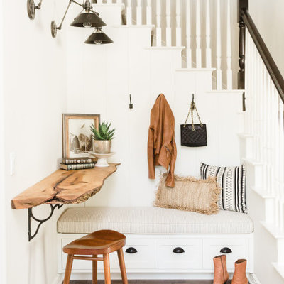 Example of a mid-sized transitional medium tone wood floor and brown floor mudroom design in San Diego with white walls