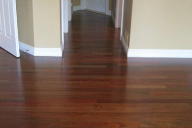 Mid-sized medium tone wood floor entry hall photo in Detroit with beige walls