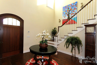 Inspiration for a timeless entryway remodel in Tampa with a dark wood front door