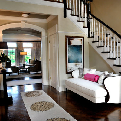 Inspiration for a large timeless dark wood floor entryway remodel in New York with beige walls