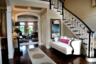 Inspiration for a large timeless dark wood floor entryway remodel in New York with beige walls