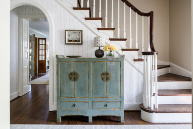 Inspiration for a transitional dark wood floor foyer remodel in DC Metro with white walls
