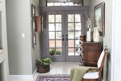 Mid-sized elegant limestone floor and beige floor entryway photo in San Diego with gray walls and a gray front door