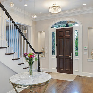 Example of a classic entryway design in Chicago with a dark wood front door and gray walls