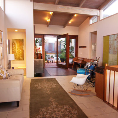 Eclectic entryway photo in San Diego with white walls
