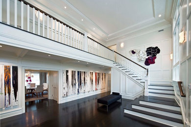 Inspiration for a contemporary dark wood floor foyer remodel in New York with white walls