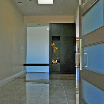 Foyer with storage cabinet, display niche and bench