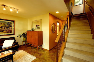 Example of a small trendy concrete floor foyer design in San Francisco with yellow walls