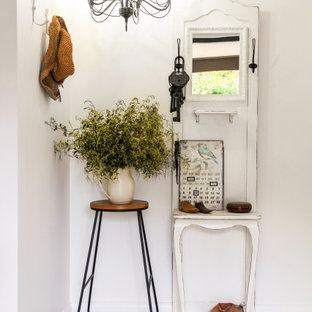 Photo of a shabby-chic style entryway in Perth with white walls and multi-coloured floor.