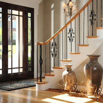 Front Entry Foyer Showing Staircase With Iron Railings