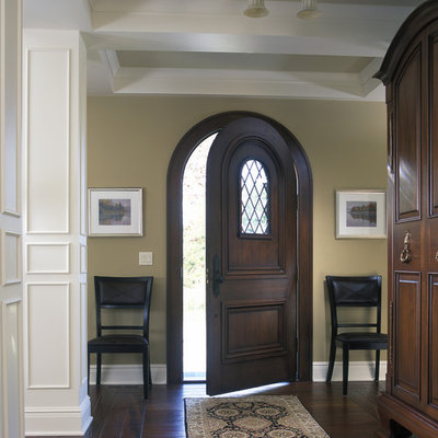 Large elegant dark wood floor single front door photo in Grand Rapids with beige walls and a dark wood front door