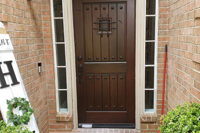 Example of an entryway design in Houston with a dark wood front door