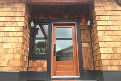 Example of a large classic slate floor and gray floor entryway design in Vancouver with a medium wood front door